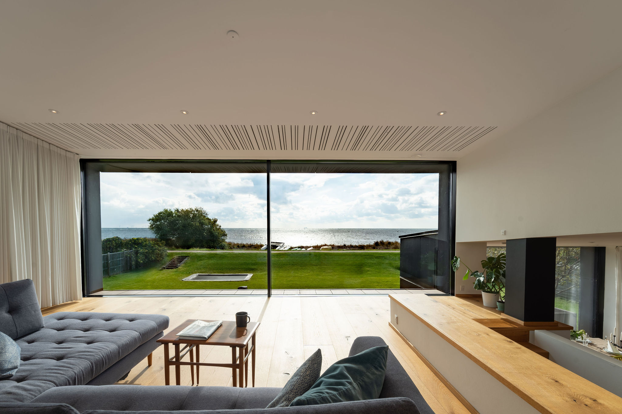 a living room with a large glass wall and a large window